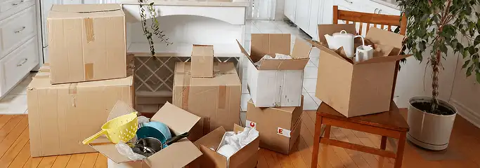 Packed moving boxes and household items in a kitchen before move-out or move-in cleaning, Jersey City, NJ.